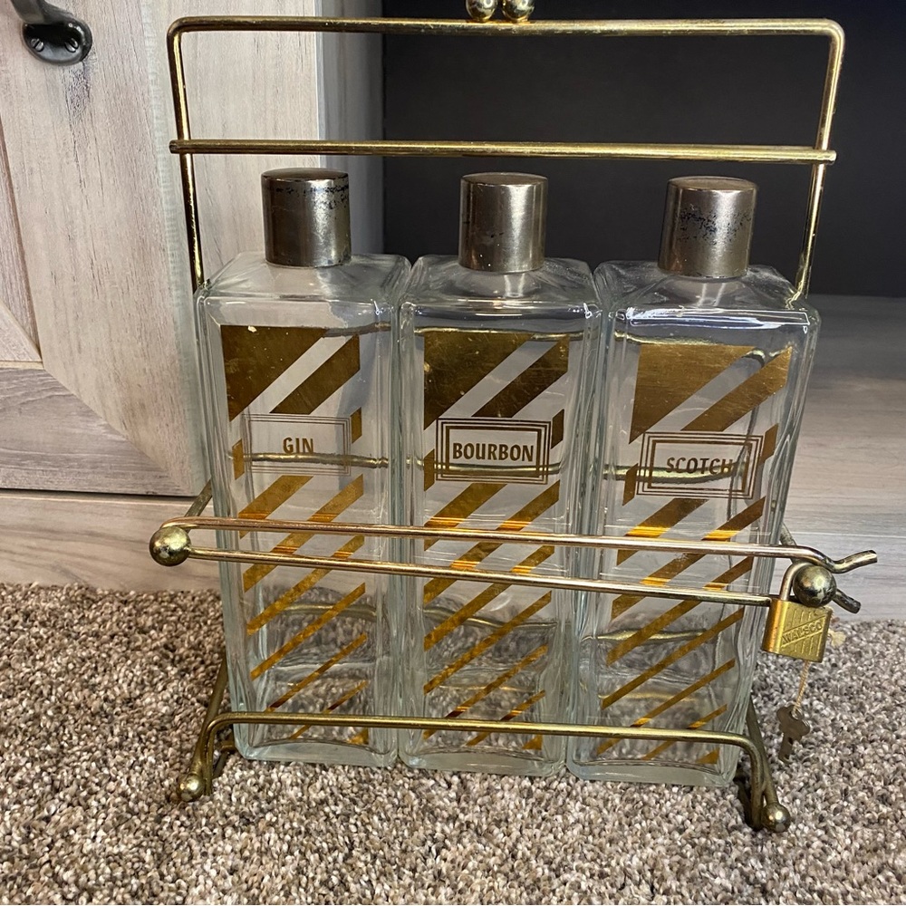 Vintage Decanter with Caddy, three bottle tantalus w Scotch, Bourbon Gin Labels